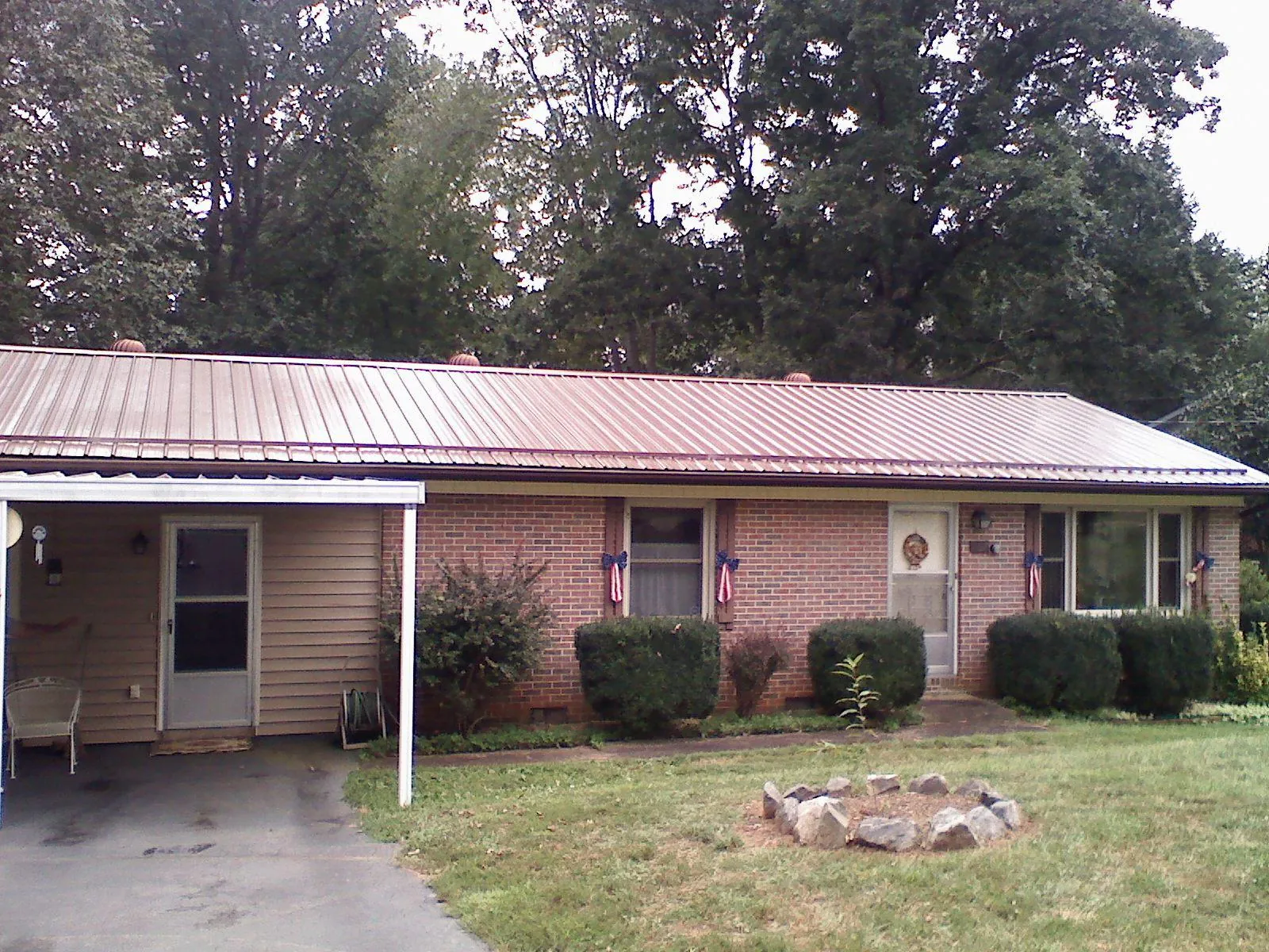 Bronze metal roof and carport on a brick ranch home — Roof Repair work by our crew in Mc Gaheysville