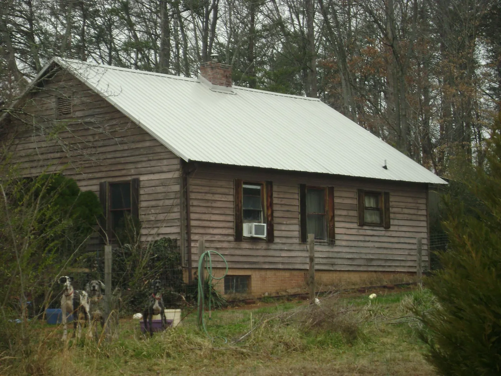 White metal roof on an old wood sided farmhouse, from a Metal Roof Installation job in Mc Gaheysville